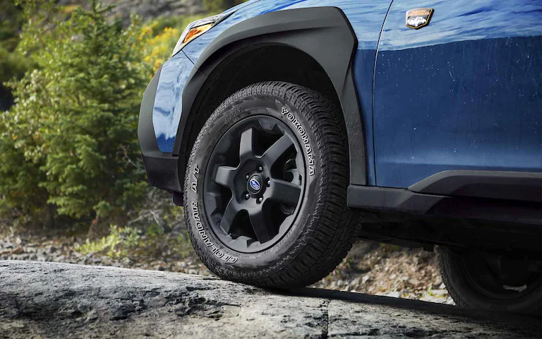 2022 Subaru Outback Wilderness driving through mud.